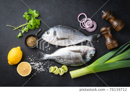 Uncooked dorado fish, spices and vegetables Uncooked dorado fish, spices and vegetables 78139712