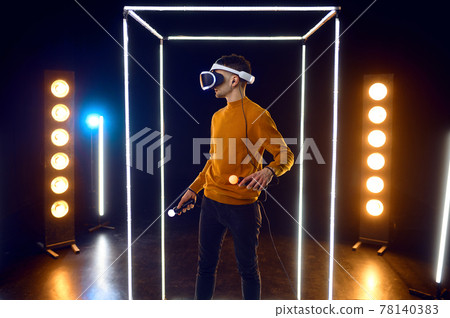 Gamer plays the game using virtual reality headset 78140383