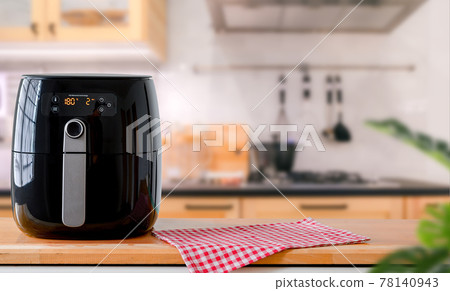Air fryer machine cooking potato fried in kitchen.  Lifestyle of new normal cooking. 78140943