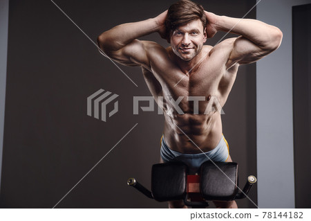 athletic man exercising pumping up muscles athletic man exercising pumping up muscles 78144182