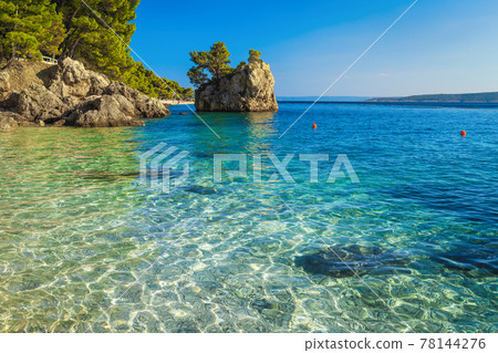 Small rock island and transparent sea in Dalmatia, Brela, Croatia 78144276