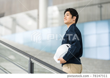 Portrait of a man who is a construction management engineer wearing work clothes Portrait of a man who is a construction management engineer wearing work clothes 78147311