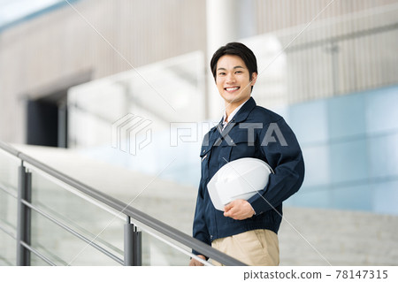 Portrait of a man who is a construction management engineer wearing work clothes Portrait of a man who is a construction management engineer wearing work clothes 78147315