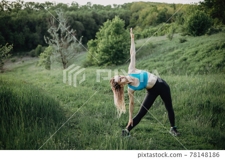 Sporty fit woman doing morning workout outdoors Sporty fit woman doing morning workout outdoors 78148186