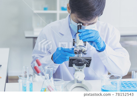 Male Scientist look into Microscope research in science laboratory. Asian scientist looking equipment laboratory chemistry labs. Covid-19 coronavirus biochemistry research experiment vaccine concept Male Scientist look into Microscope research in science laboratory. Asian scientist looking equipment laboratory chemistry labs. Covid-19 coronavirus biochemistry research experiment vaccine concept 78152543