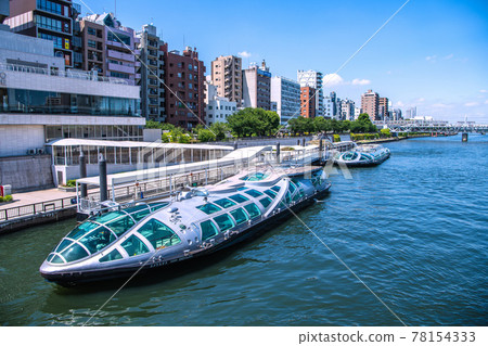 Tokyo cityscape of Japan Sumida River and water buses "Emeraldas" and "Hotaruna". Train in the back 78154333