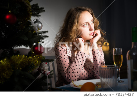 Sad woman celebrating New Year 78154427