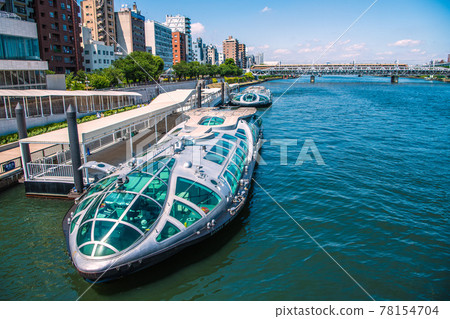 Tokyo cityscape of Japan Sumida River and water buses "Emeraldas" and "Hotaruna". Limited express in the back 78154704