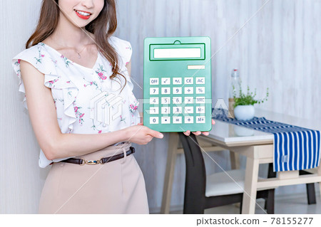 在新公寓裡拿著計算器的年輕女人 78155277