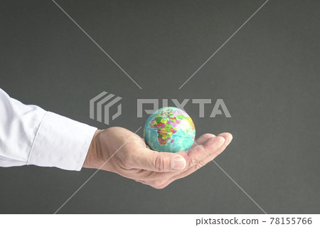 Businessman holding the world in the palm of hand. Businessman holding the world in the palm of hand. 78155766