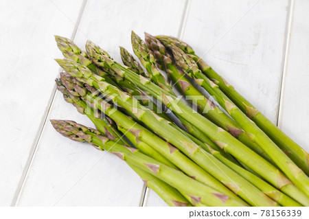 Hokkaido green asparagus placed on a white board 78156339
