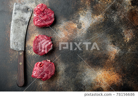Raw fresh marbled meat Steak filet mignon , and old butcher cleaver knife, on old dark rustic background, top view flat lay, with copy space for text 78156686