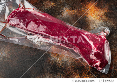 Fillet beef vacuum bag for sous vide, on old dark rustic background 78156688