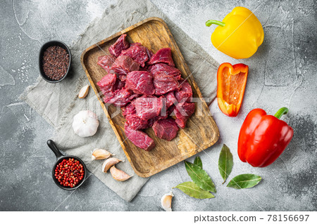 Fresh raw chopped beef with sweet bell pepper, on gray stone background, top view flat lay Fresh raw chopped beef with sweet bell pepper, on gray stone background, top view flat lay 78156697