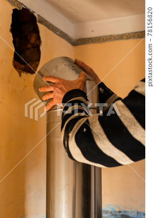 Chimney for the fireplace, installation of a pipe over the fireplace to the chimney, repair work in the house. 78156820