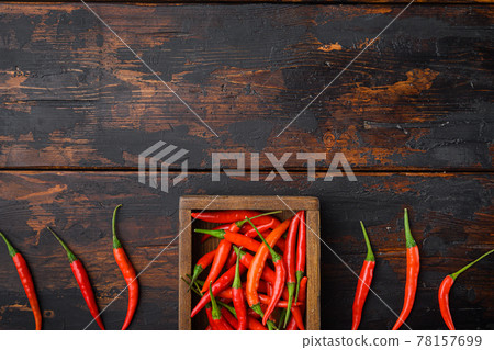 Long fed pepper, in wooden box, on old dark wooden table , top view flat lay, with copy space for text 78157699