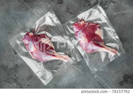 Duck organic leg meat vacuum sealed, on gray stone background, top view flat lay 78157762