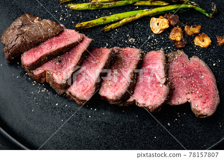 Grilled fillet mignon beef steak, with onion and asparagus, on plate 78157807