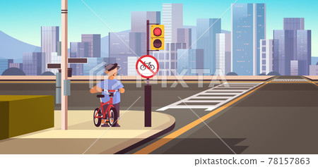 schoolboy with bicycle standing near red round kike ban sign road safety concept horizontal cityscape background 78157863