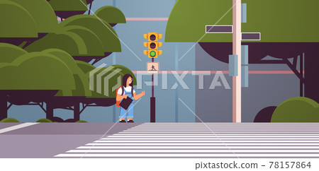 schoolgirl with backpack waiting for green traffic light to cross road on crosswalk road safety concept cityscape 78157864