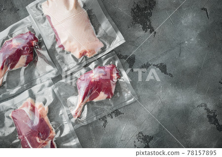 Duck meat vacuum packed, on gray stone background, top view flat lay, with copyspace and space for text Duck meat vacuum packed, on gray stone background, top view flat lay, with copyspace and space for text 78157895