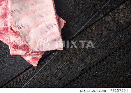 Raw pork meat ribs, on black wooden table background, top view flat lay, with copy space for text Raw pork meat ribs, on black wooden table background, top view flat lay, with copy space for text 78157994