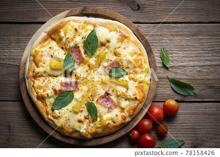 Tasty pizza homemade italian food style, pizza cheese ham and pineapple fruit cooking ingredients tomatoes basil on wooden background, Top view of pizza cheese italian food style. Flat lay 78158426