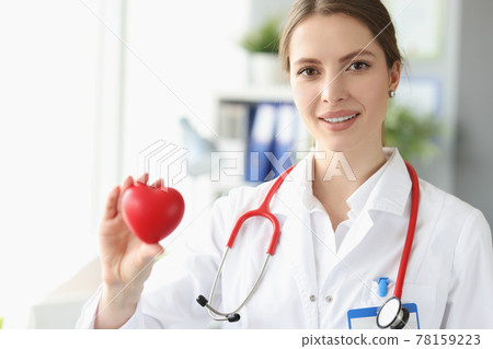 Portrait of female doctor cardiologist with small heart in her hand 78159223