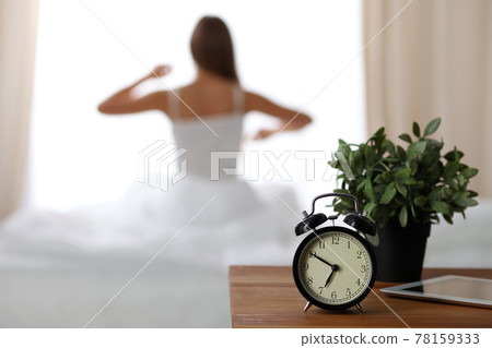Woman stretching in bed after wake up, back view, entering a day happy and relaxed after good night sleep. Sweet dreams, good morning, new day, weekend, holidays concept Woman stretching in bed after wake up, back view, entering a day happy and relaxed after good night sleep. Sweet dreams, good morning, new day, weekend, holidays concept 78159333