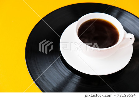 Cup of black coffee on vynil record. Copy space. Listening to music. Retro style Cup of black coffee on vynil record. Copy space. Listening to music. Retro style 78159554