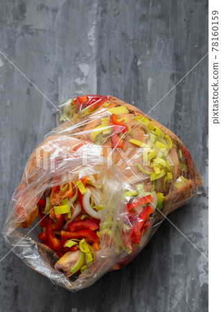 chicken with herbs, red pepper, onion in plastic bag for cook 78160159