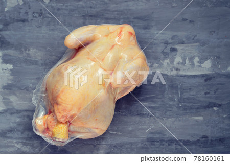 chicken in vacuum bag on ceramic background 78160161