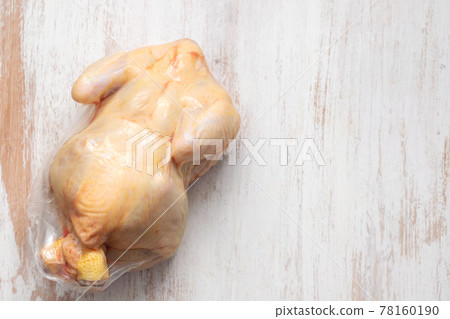 chicken in vacuum bag on wooden background 78160190