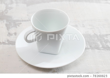 white cup on ceramic background 78160823