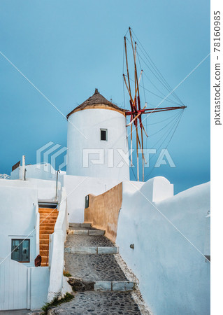 Old greek windmill on Santorini island in Oia town with stairs in street. Santorini, Greece 78160985