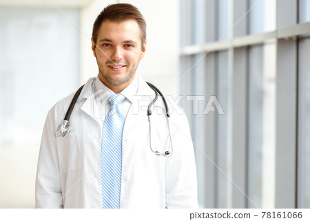 Male dark hair doctor standing in the modern clinic. Perfect medical service in the hospital. Medicine concept Male dark hair doctor standing in the modern clinic. Perfect medical service in the hospital. Medicine concept 78161066