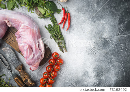 Whole raw rabbit with ingredients, on gray stone background, top view flat lay, with copy space for text 78162492