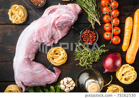 Fresh meat. Whole rabbit ready to cook stew tagliatelle, on old dark wooden table background, top view flat lay Fresh meat. Whole rabbit ready to cook stew tagliatelle, on old dark wooden table background, top view flat lay 78162530