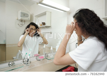 Vietnamese guy adjusting eyeglasses 78162940