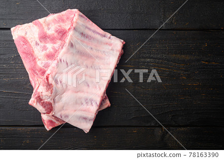 Raw Pork ribs, on black wooden table background, top view flat lay, with copy space for text Raw Pork ribs, on black wooden table background, top view flat lay, with copy space for text 78163390