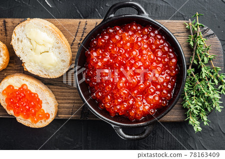 Canape toast with red caviar, on black background Canape toast with red caviar, on black background 78163409