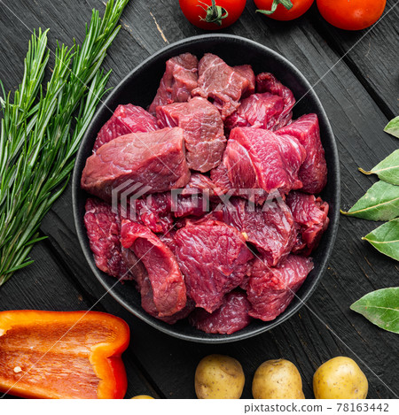 Beef chuck stew ingredients , on black wooden background, top view flat lay, square format Beef chuck stew ingredients , on black wooden background, top view flat lay, square format 78163442