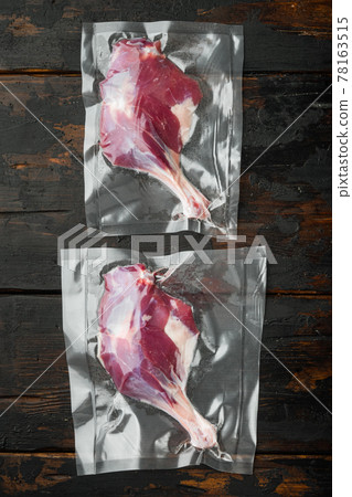 Duck raw leg, raw freshly slaughtered by the bio farm prepared for vacuuming and smoking, on old dark wooden table background 78163515