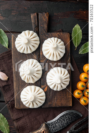 Khinkali Dumplings with beef and lamb meat, on old dark wooden table background, top view flat lay 78163522