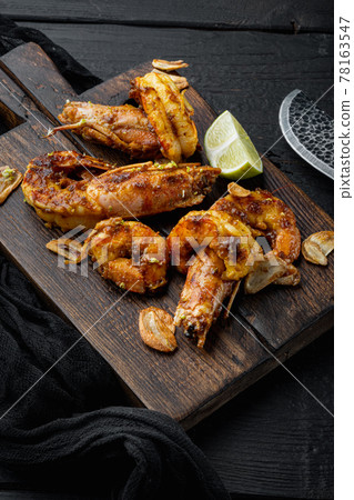 Grill red Argentinian prawns cooking seafood, on wooden board, on black wooden table background 78163547