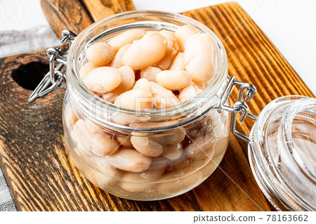 White canned kidney beans, in glass jar, on white stone surface White canned kidney beans, in glass jar, on white stone surface 78163662