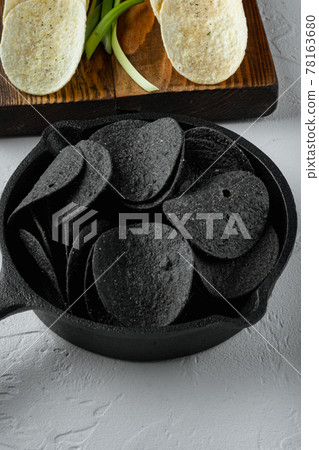 Cheese and chive potato crisp snack , with dipping sauces tomato dip sour cream, on white stone surface 78163680