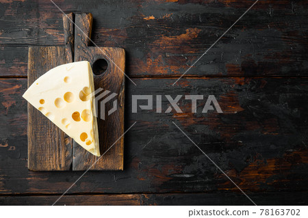 Maasdam cheese, on old dark wooden table , top view flat lay, with copy space for text Maasdam cheese, on old dark wooden table , top view flat lay, with copy space for text 78163702