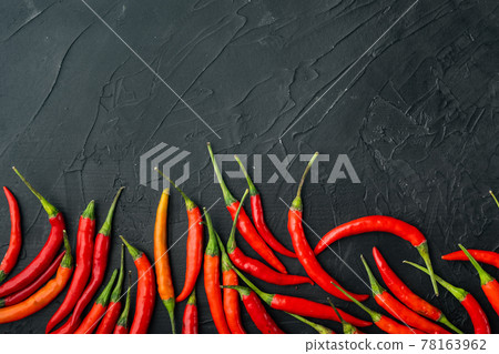Ripe Cayenne pepper, on black stone background, top view flat lay, with copy space for text 78163962