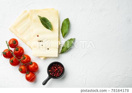 Organic lasagna pasta sheets, with seasoning and herb, on white stone background, top view, flat lay, with copy space for text 78164178